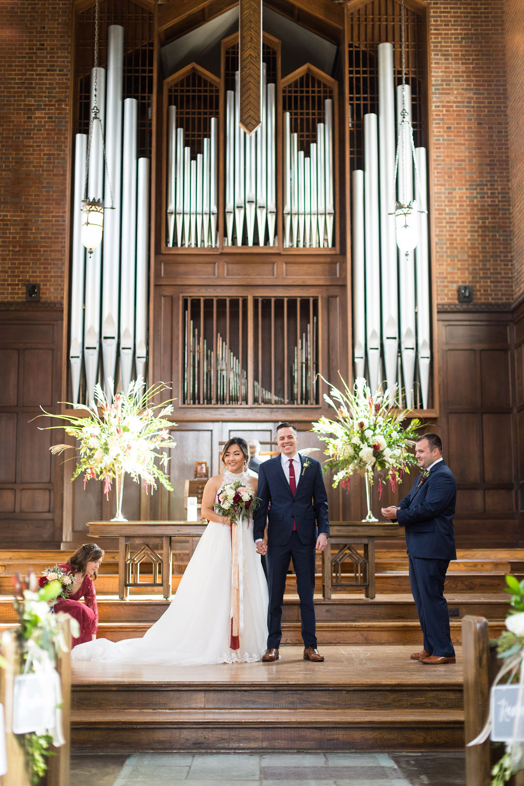 Couple standard at the altar in Wightman, smiling toward guests