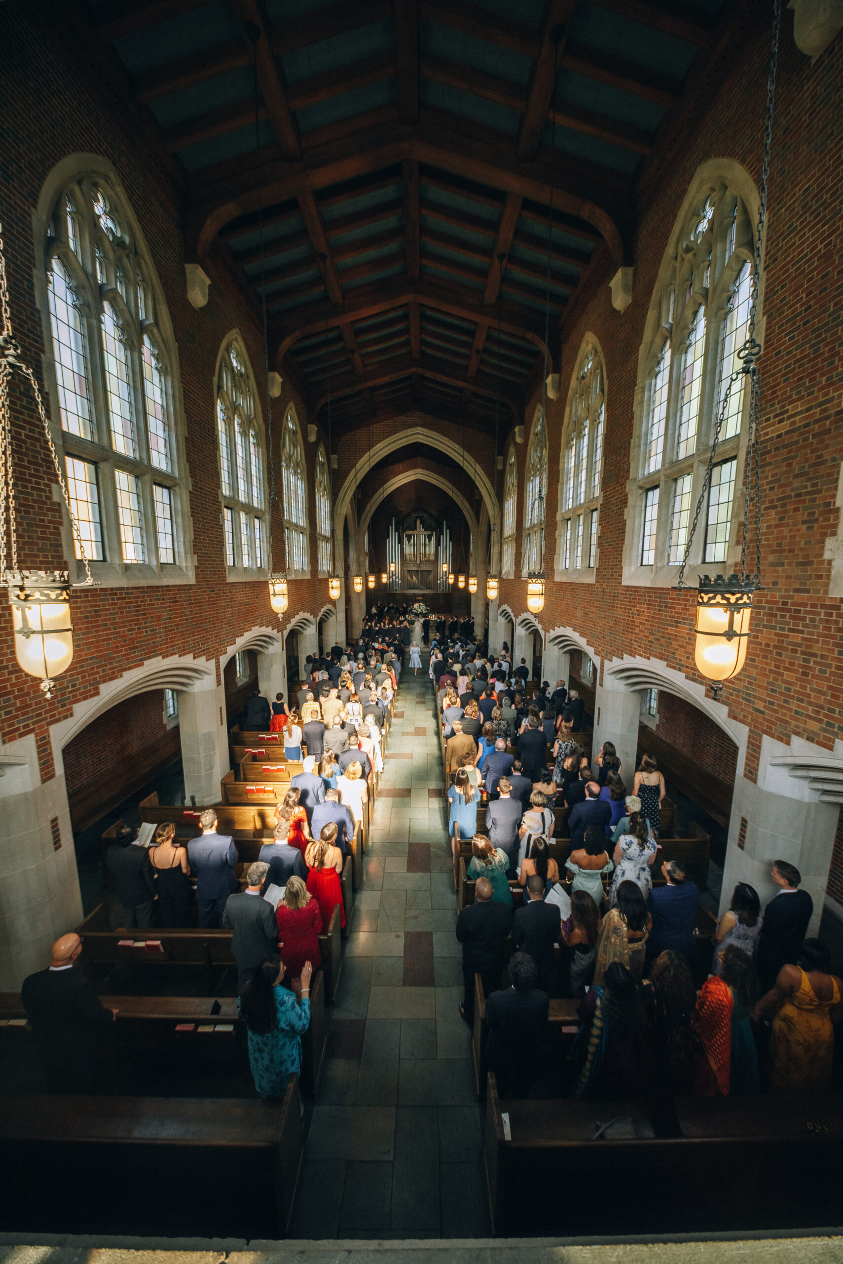Sweeping view of Wightman Chapel from above, during a wedding ceremony