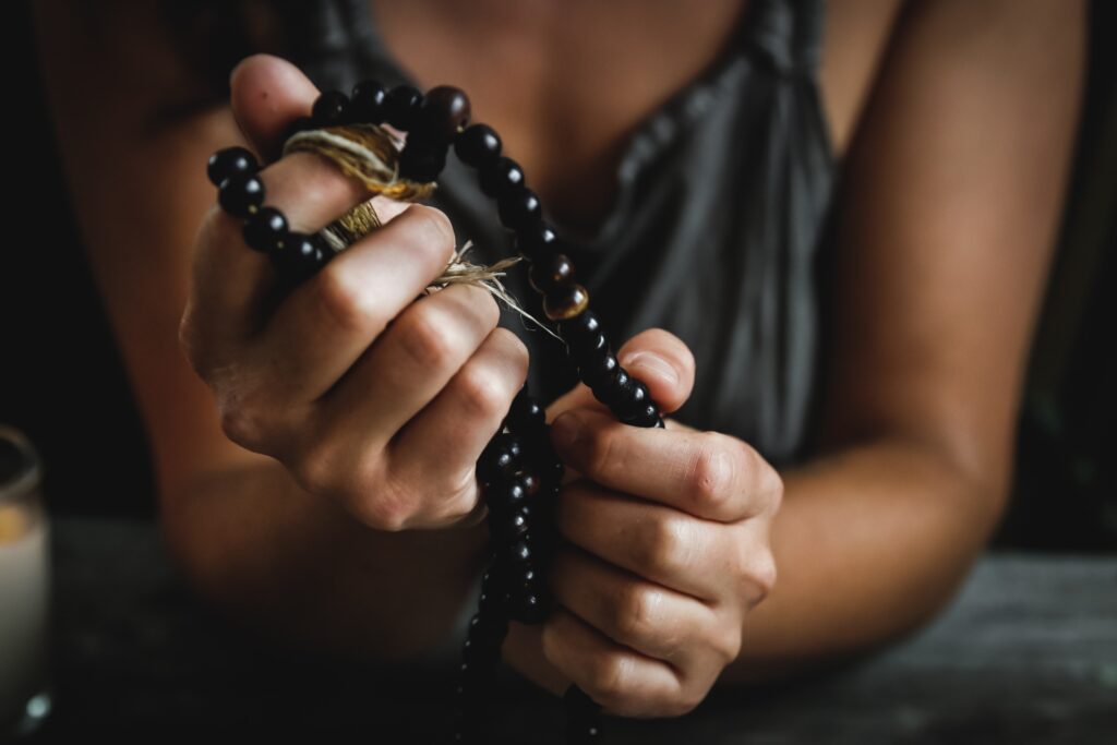 Person holding prayer beads