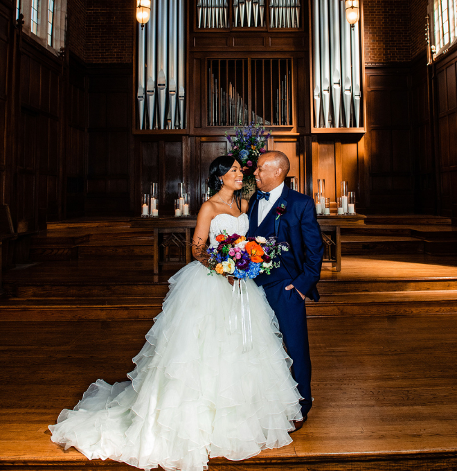 Bride and groom smiling at each other in Wightman Chapel